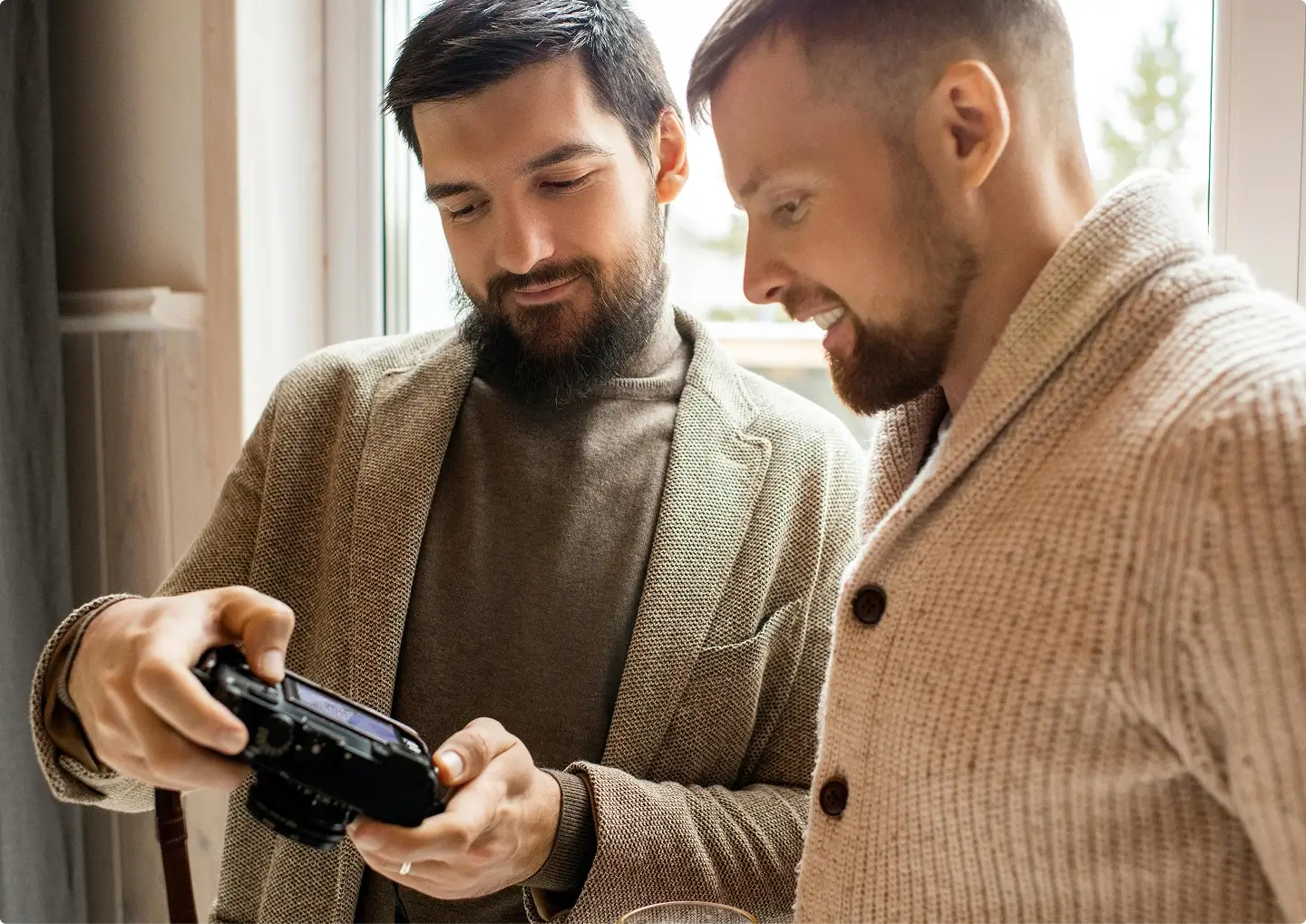 Real estate photographer discussing property details with a realtor/agent on-site, showcasing professional service.