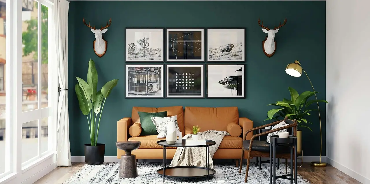 Stylish modern home office or study area featuring dark green walls, framed artwork, and a wooden desk setup with warm lighting.