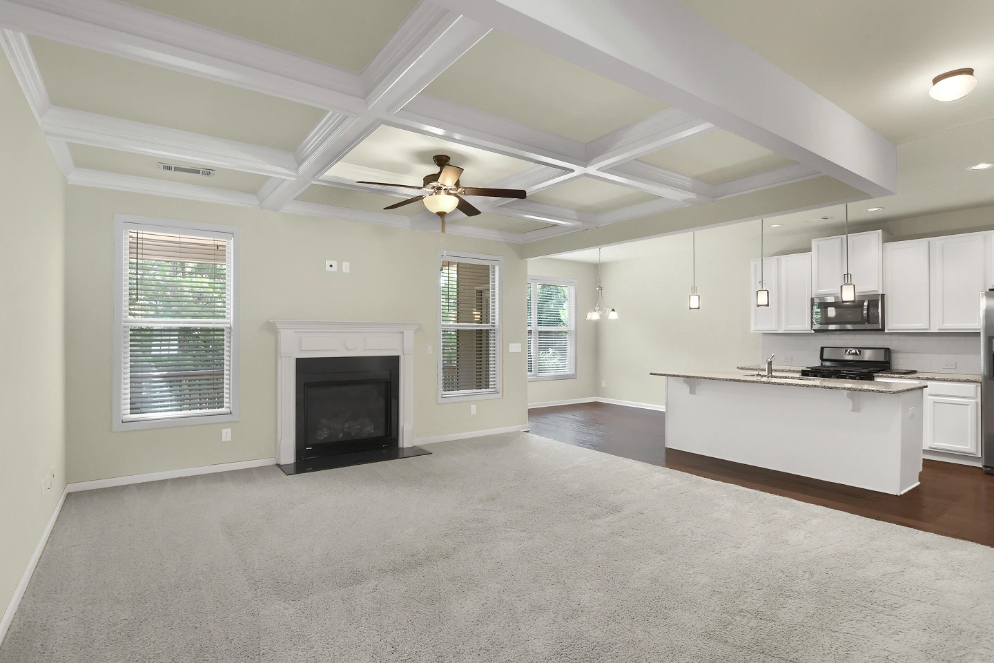 Spacious, elegant living room with a vaulted ceiling and a view of the home's open layout.