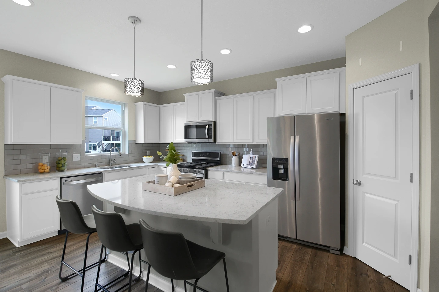 Bright, modern kitchen interior with light gray island and white cabinets, perfect for a high-end real estate listing.