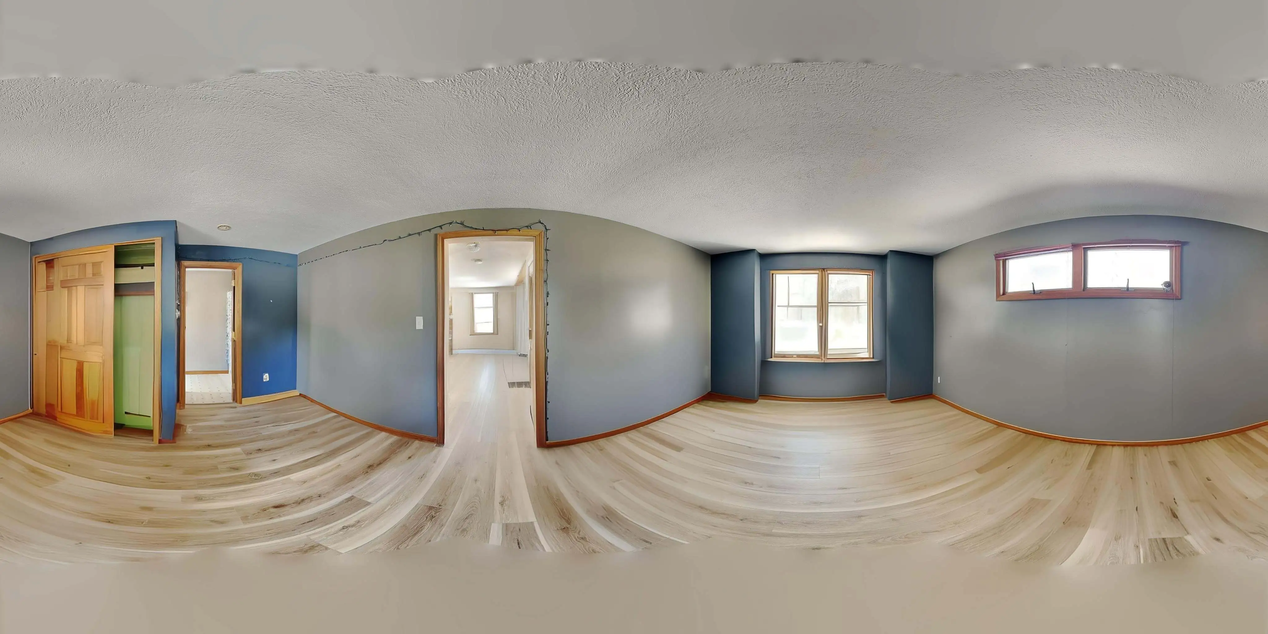 360-degree panoramic virtual tour image showing a staged living area after virtual decluttering, highlighting enhanced interior presentation.