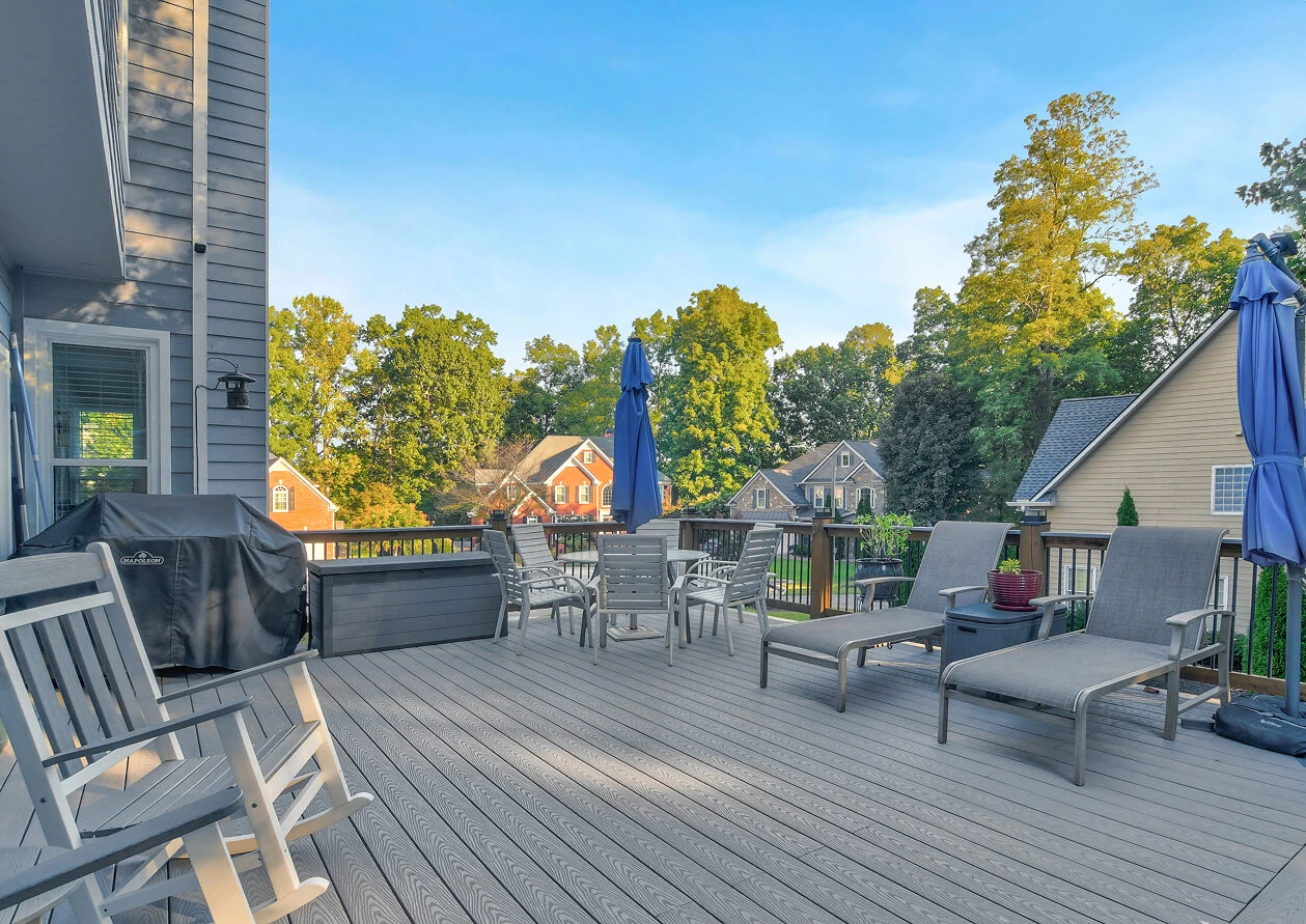 Stunning outdoor patio with stone paving, comfortable seating, and a large stone fireplace, ideal for showcasing outdoor living features.